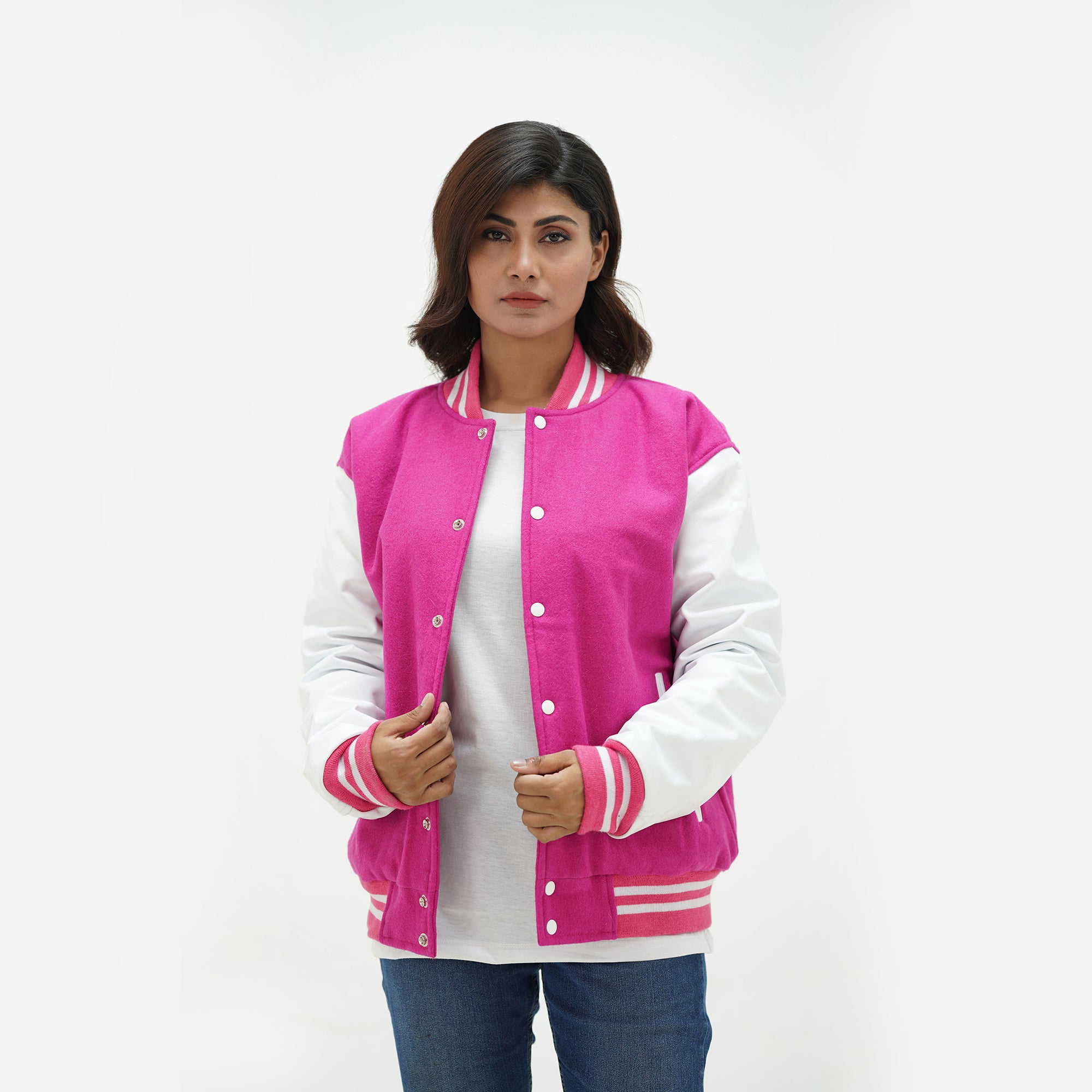 Women's pink varsity jacket side angle - displaying feminine fit with genuine leather sleeves and ribbed cuffs detail