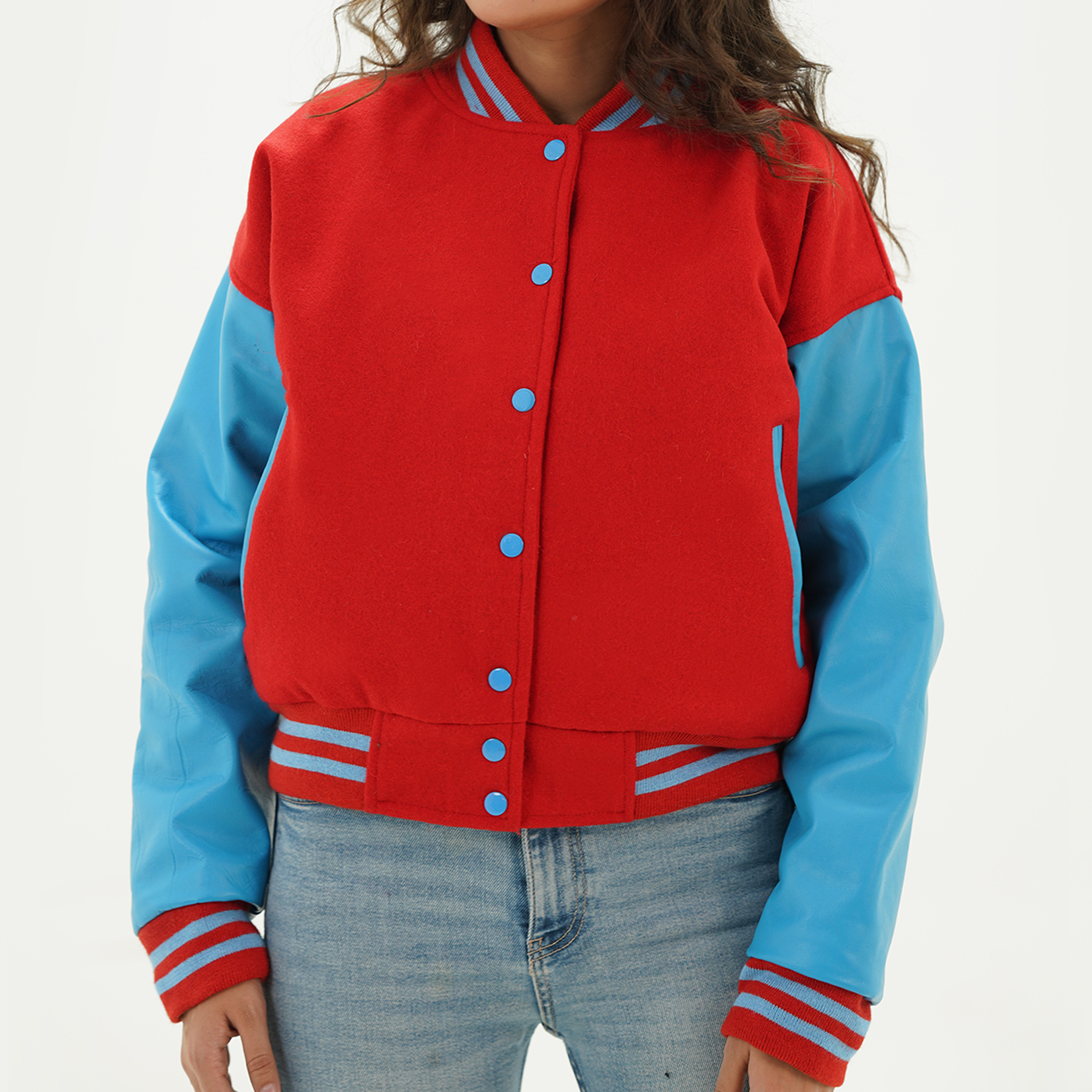 Women's red and sky blue varsity jacket front view with red wool body, sky blue leather sleeves, snap button closure, and ribbed collar
