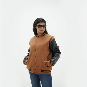 Side profile of women's red white and blue letterman jacket showing white genuine leather sleeves and ribbed cuff details