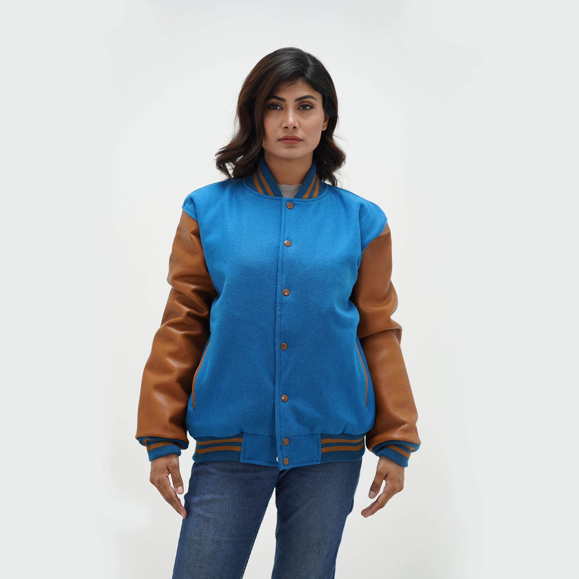 Women's sky blue varsity jacket full body fit - tailored silhouette with brown leather arms, side pockets, and classic ribbed waistband
