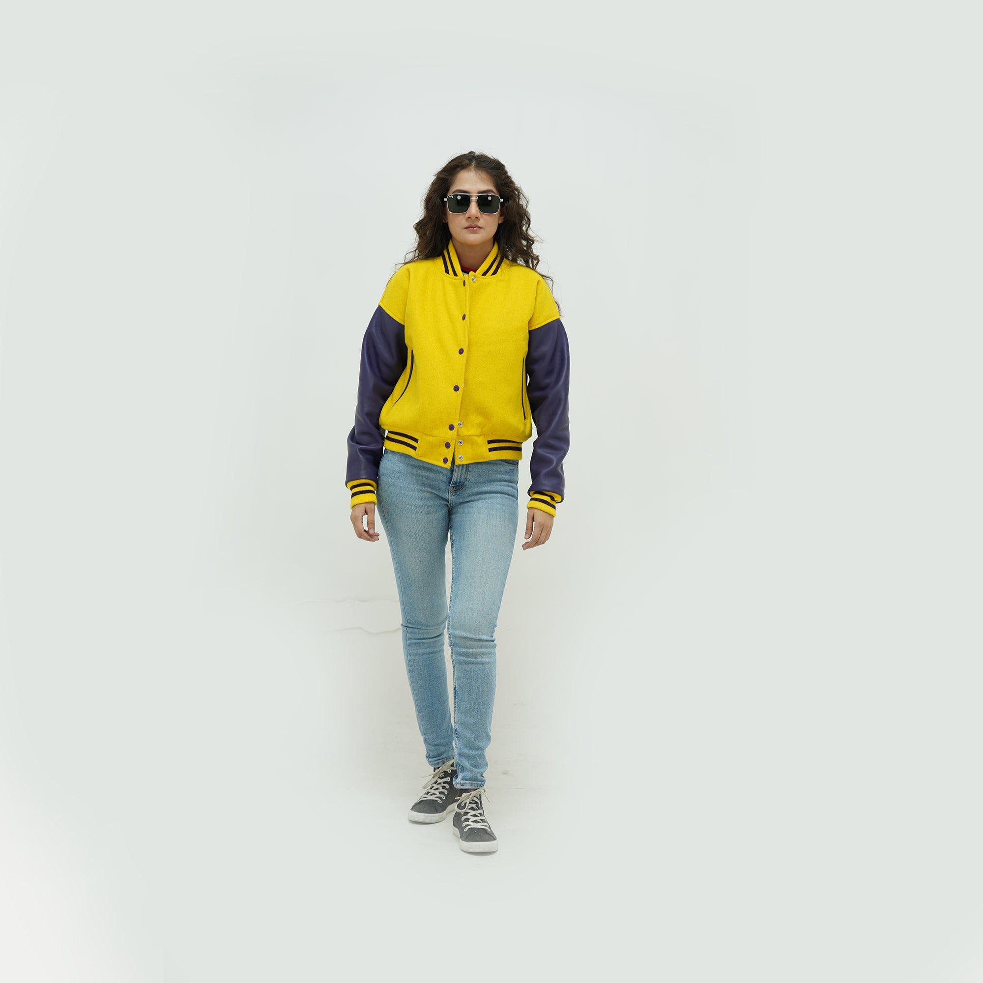 Full display of women's yellow and blue varsity jacket showing complete fit, premium materials, and eye-catching yellow-blue varsity styling